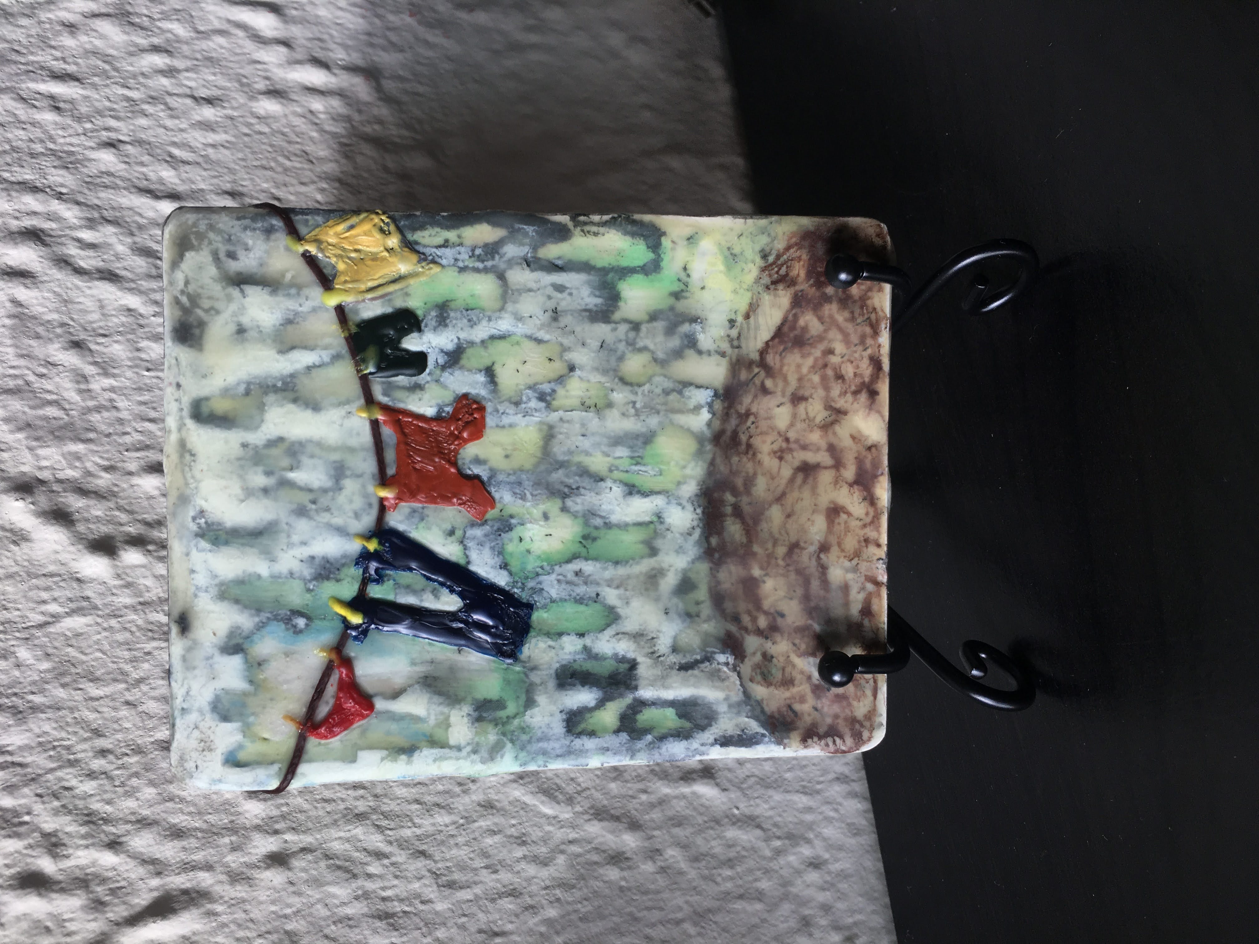 Encaustic art of clothes drying on a clothesline with abstract backround